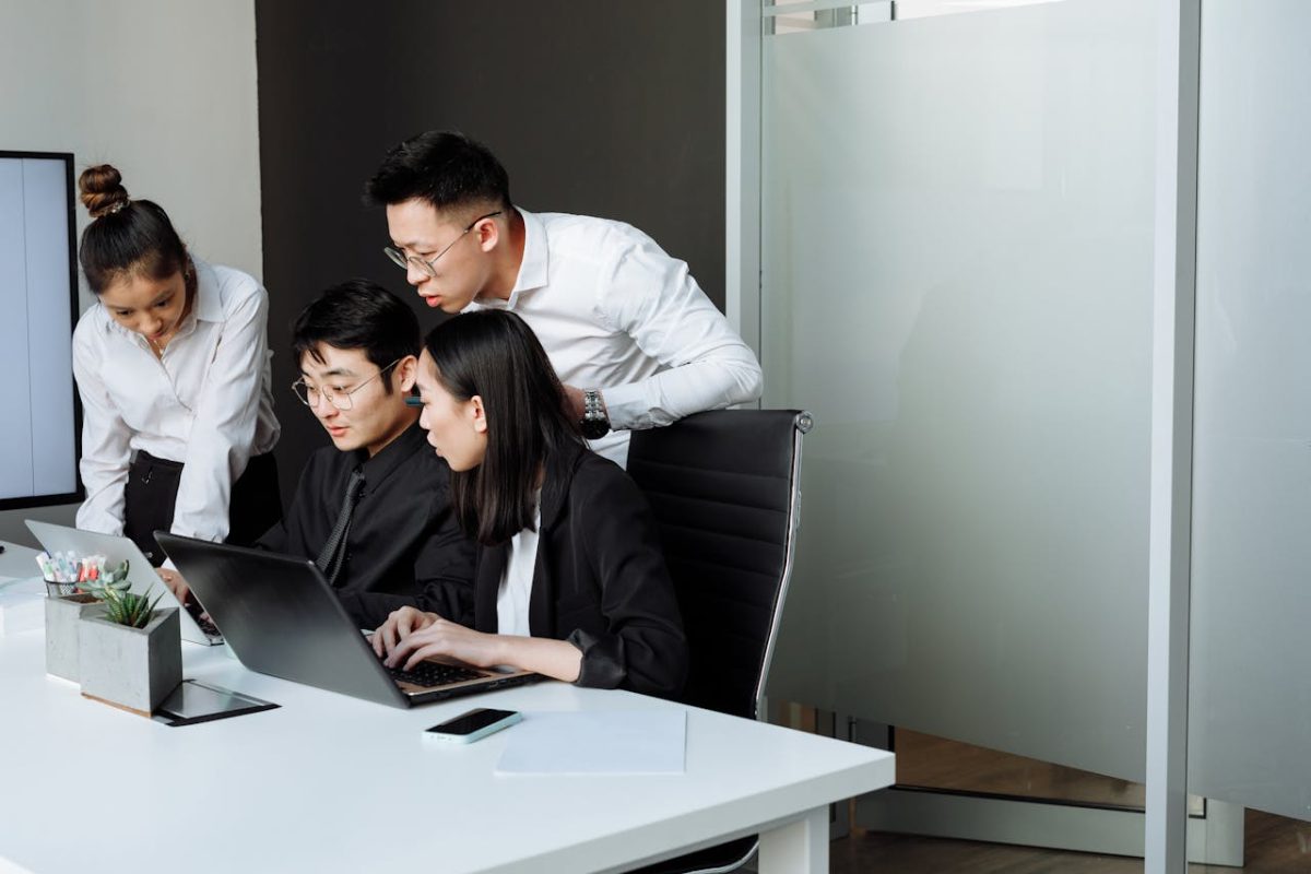 A group of corporate workers huddled in a table