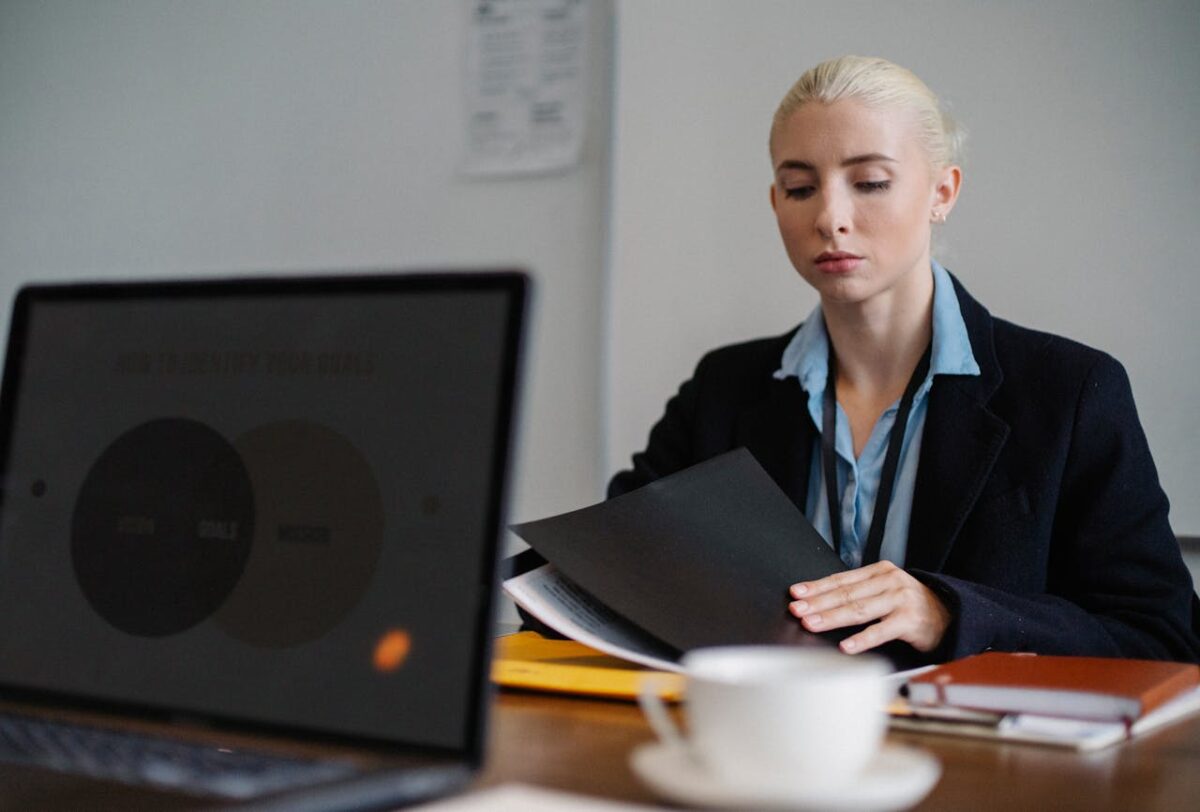 A secretary at her desk with some files