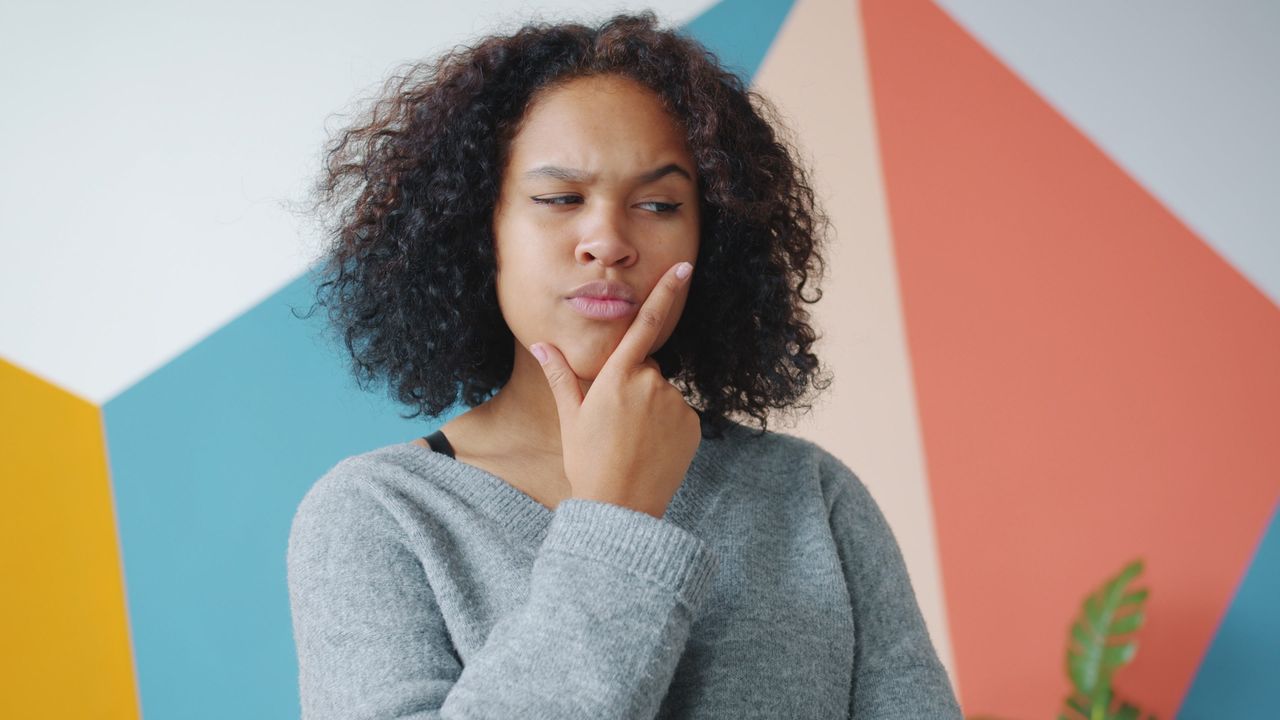 A woman deciding between Singapore or Hong Kong to establish a holding company